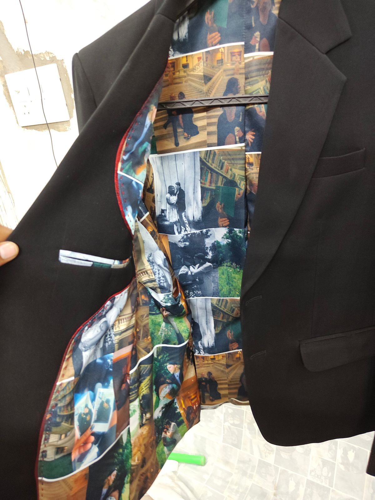 Black men's blazer opened to reveal personalized photo collage lining with memorable travel and family photos